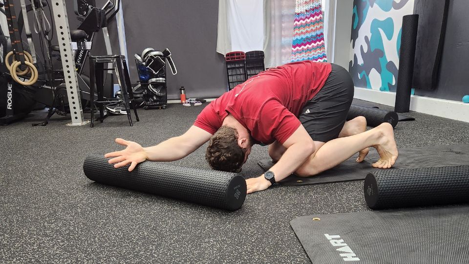 Man Stretching Upper Body | Featured Image for the Stretch & Recover Landing Page for AB Fitness Hub